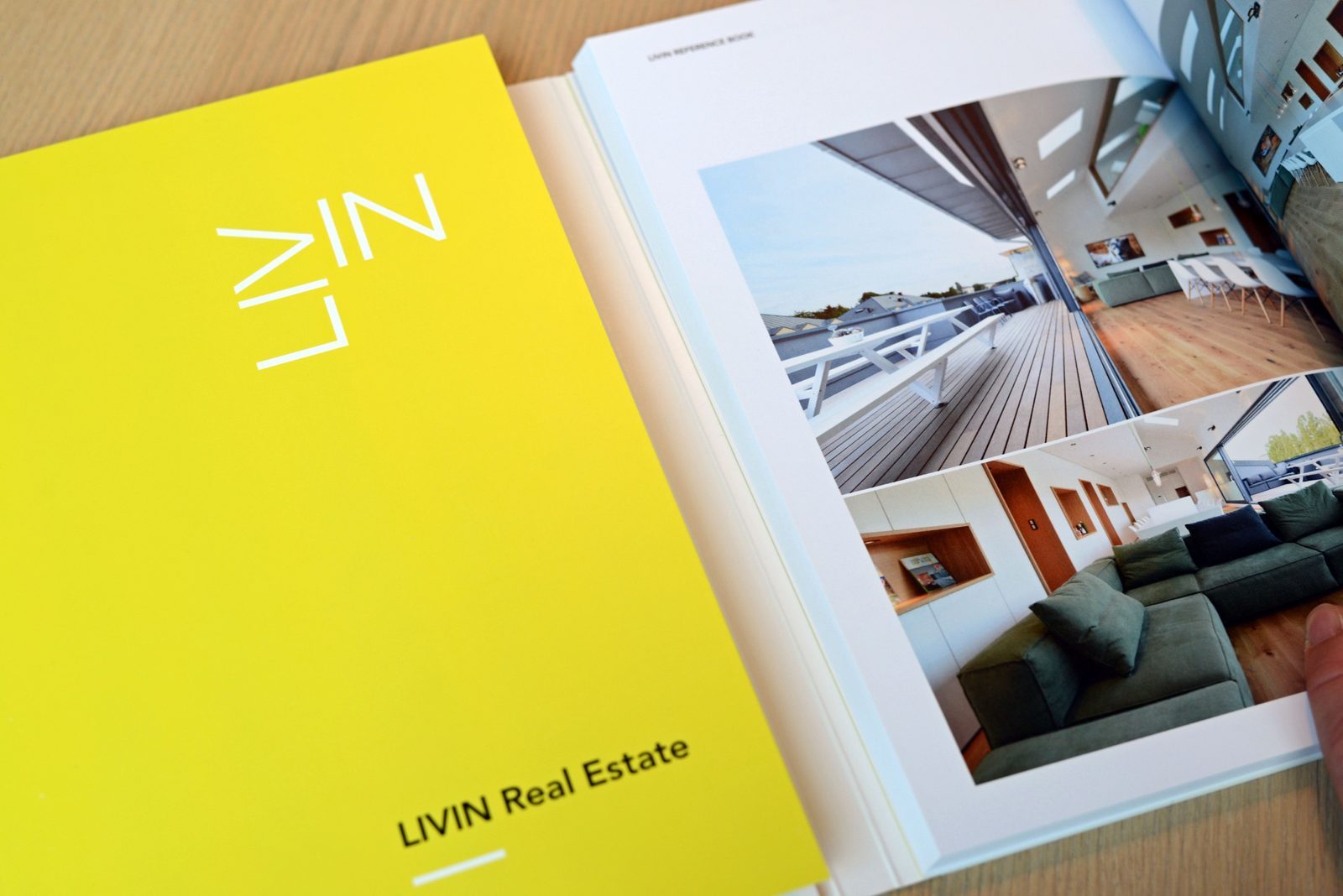 The yellow LIVIN Real Estate reference book, opened on an interior photo