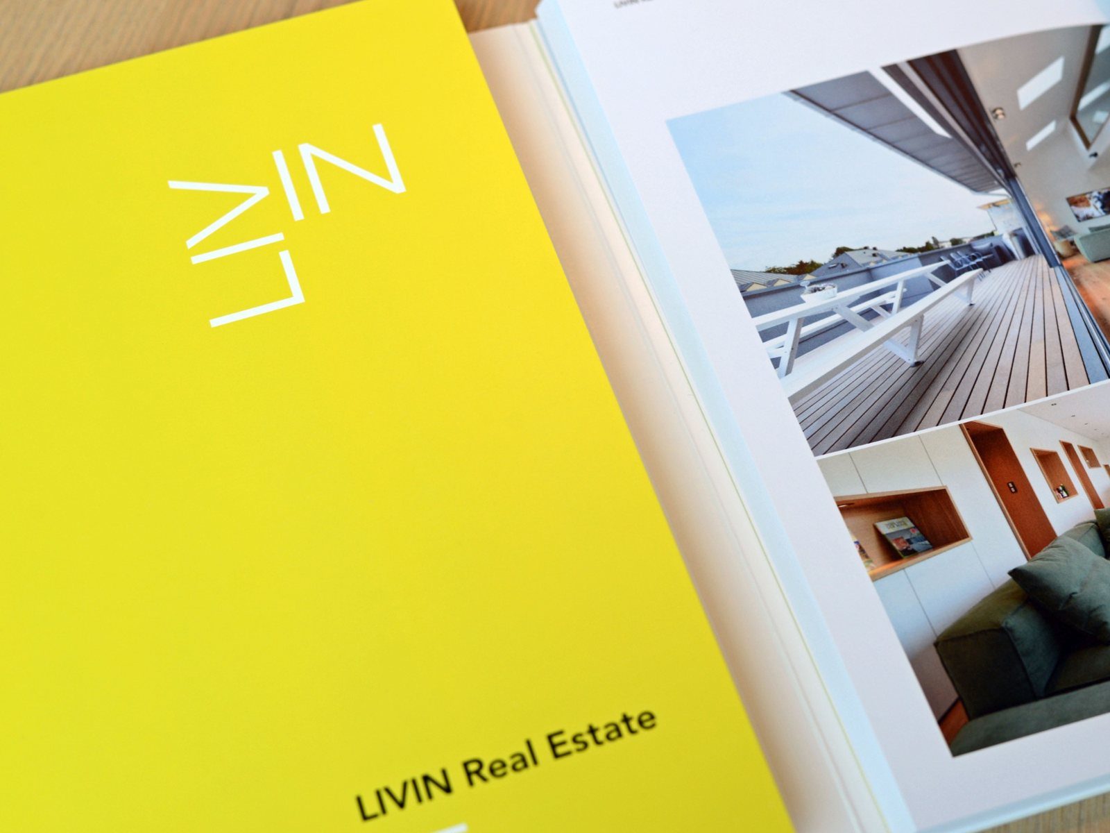 The yellow LIVIN Real Estate reference book, opened on interior photos
