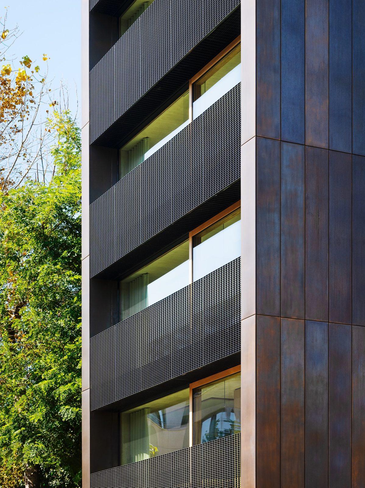 Detail of the The Stik façade: bronze cladding, black steel grilles and wooden window frames